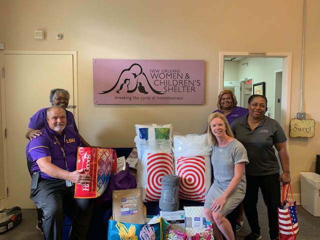 Photo of faculty and staff with donations for a shelter